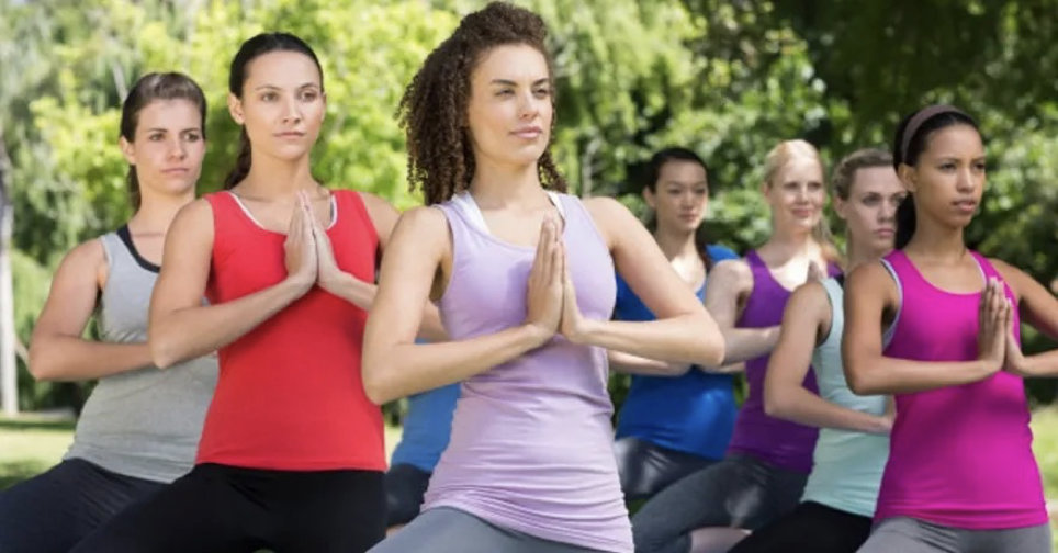 group of women doing outdoor yoga