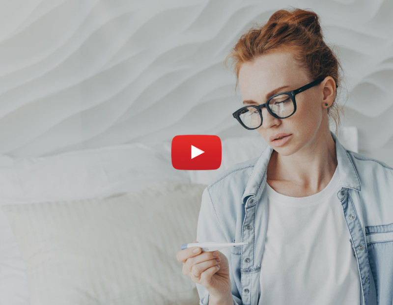 Young red headed woman with glasses looking at a pregnancy test