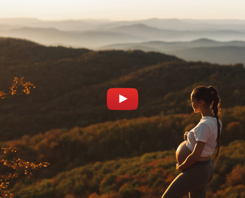 Young pregnant woman walking in the country