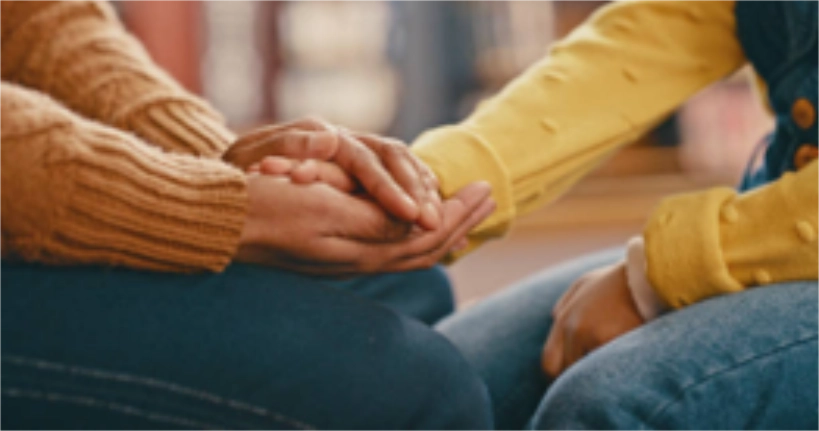 Two women talking and holiding hands