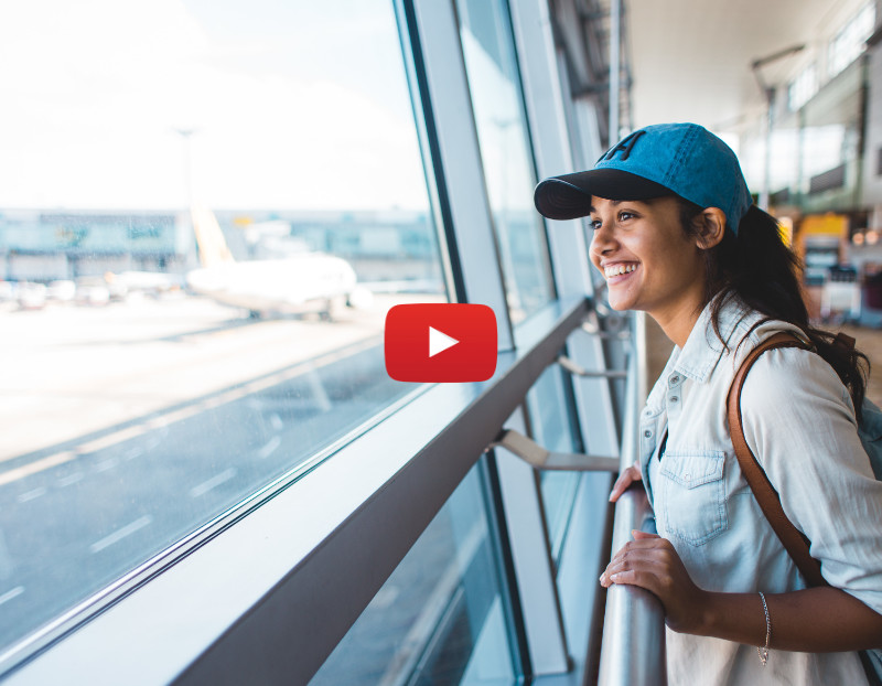 Young simling woman waiting for a plane at the airport